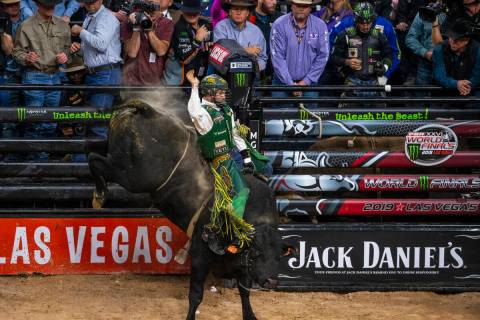 Jess Lockwood rides tall on Rising Sun during the last day of the PBR World Finals at T-Mobile ...