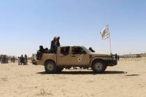 Taliban fighters patrol inside the city of Ghazni, southwest of Kabul, Afghanistan, Friday, Aug ...