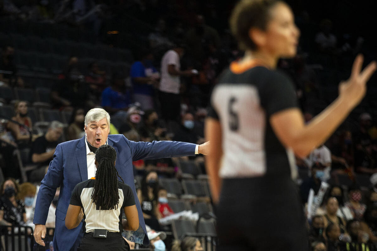 Las Vegas Aces head coach Bill Laimbeer has a disagreement with a referee while another referee ...