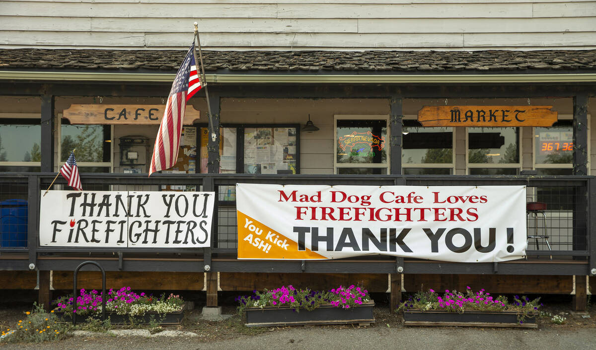 Banners thank firefighters while hanging on the front of the Mad Dog Cafe as the Caldor Fire co ...