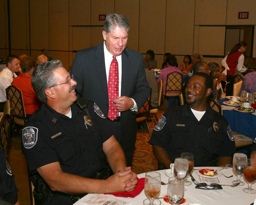 News anchor Gary Waddell, center, talks with North Las Vegas Police Capt. Paul Womacjk and Dep ...