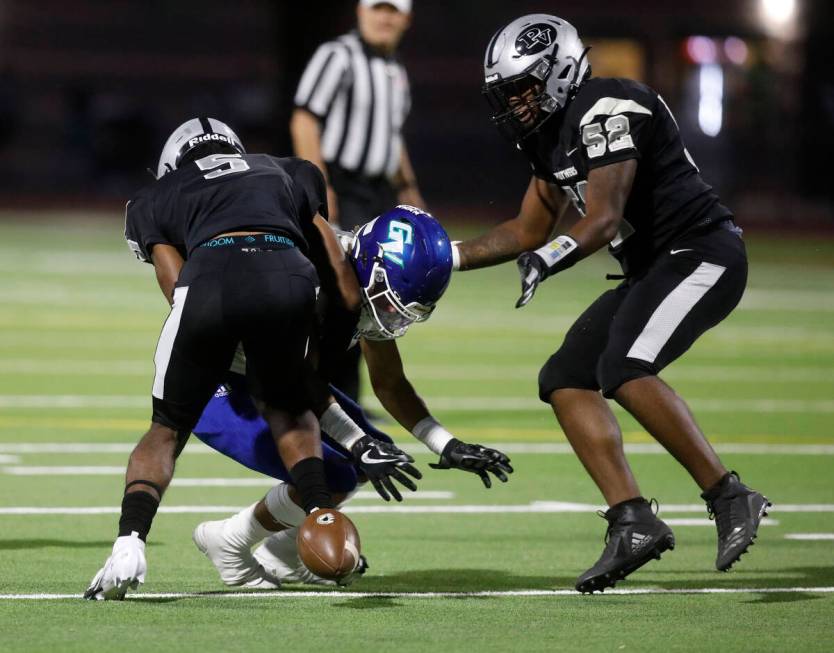 Green Valley High School's Logan Squires (55) fumbles the ball during the first half of a footb ...