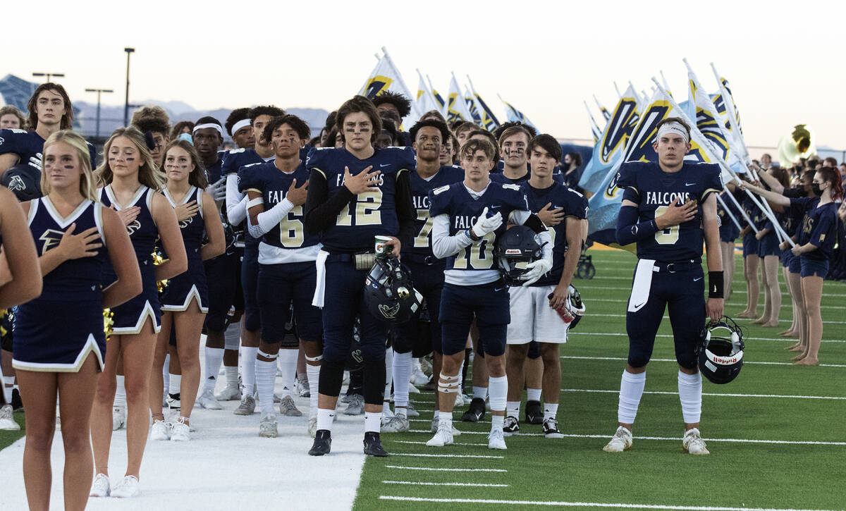 Foothill HighÕs cheerleaders and players place their right hand over their heart during th ...