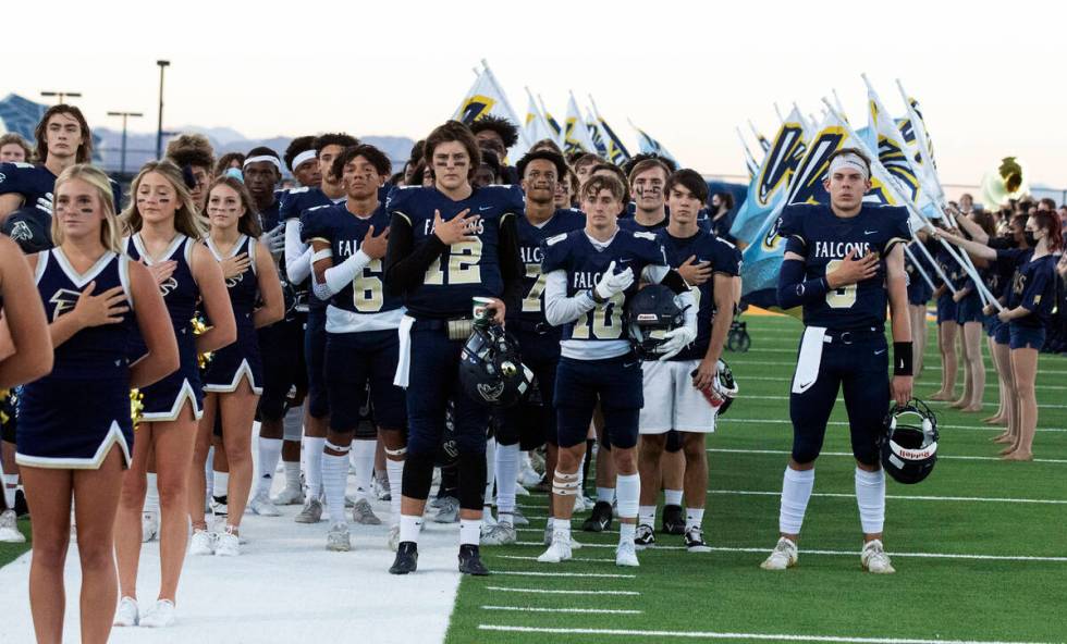 Foothill HighÕs cheerleaders and players place their right hand over their heart during th ...