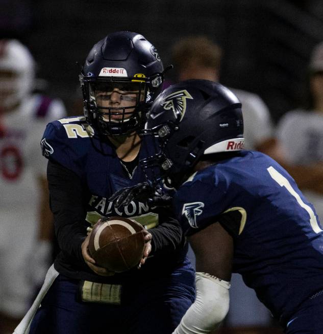 Foothill HighÕs quarterback Cameron Paul (12) hands the ball off to running back Kendric T ...