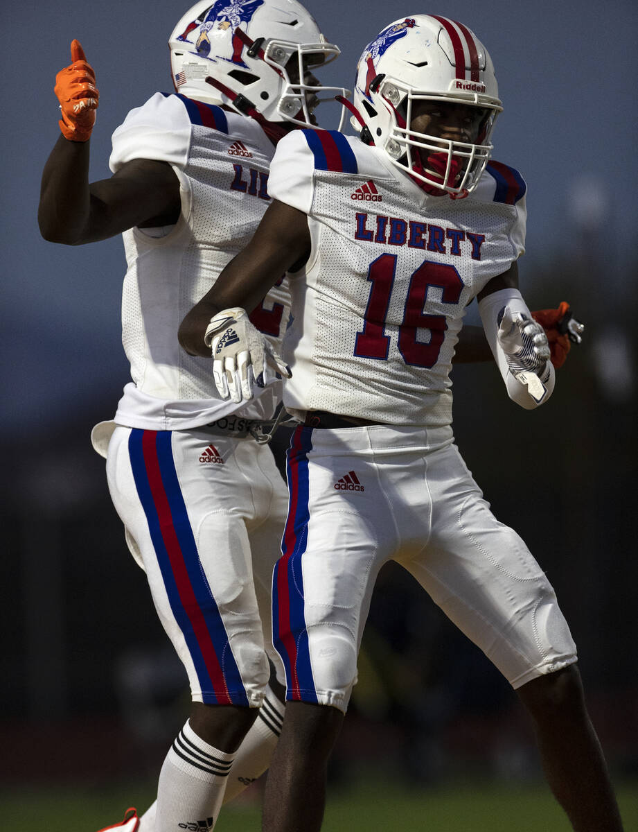 Liberty HighÕs wide receivers Germie Bernard (2) and Ethan Hillard (16) celebrate Bernard& ...