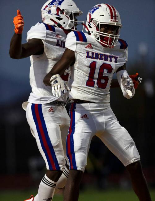 Liberty HighÕs wide receivers Germie Bernard (2) and Ethan Hillard (16) celebrate Bernard& ...