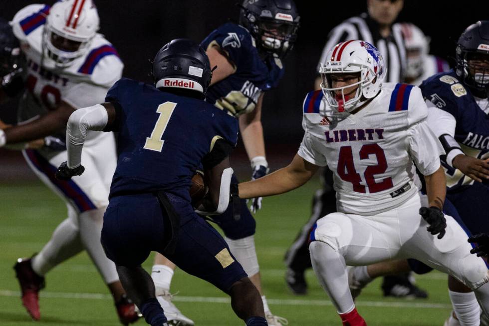 Foothill High running back Kendric Thomas (1) avoids a tackle from Liberty High's defensive lin ...