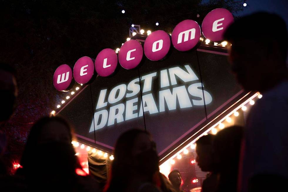 Fans wait in line to take photos in front of the welcome sign during the Lost in Dreams music f ...