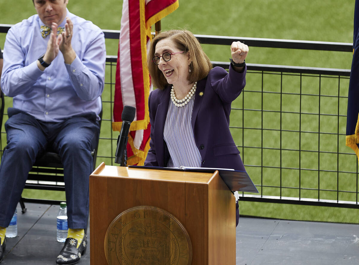 FILE - In this Wednesday, June 30, 2021, file photo, Oregon Gov. Kate Brown pumps her fist whil ...