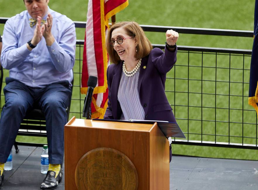 FILE - In this Wednesday, June 30, 2021, file photo, Oregon Gov. Kate Brown pumps her fist whil ...