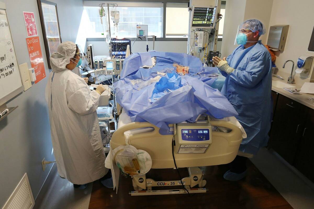 Memorial Hospital registered nurse Steve Menchaca, right, and Emily Rentquiano tend to a patien ...