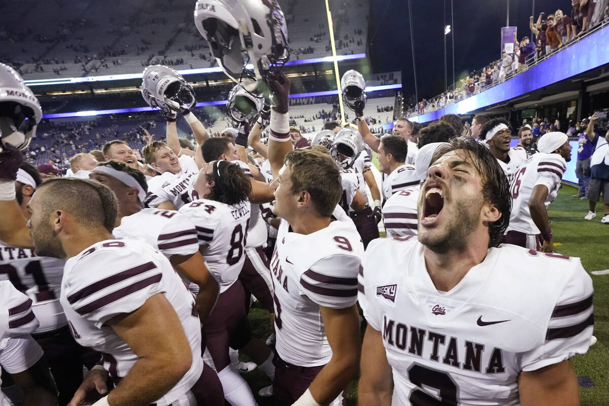 Montana quarterback Cam Humphrey lets out a yell as he celebrates with teammates after they bea ...