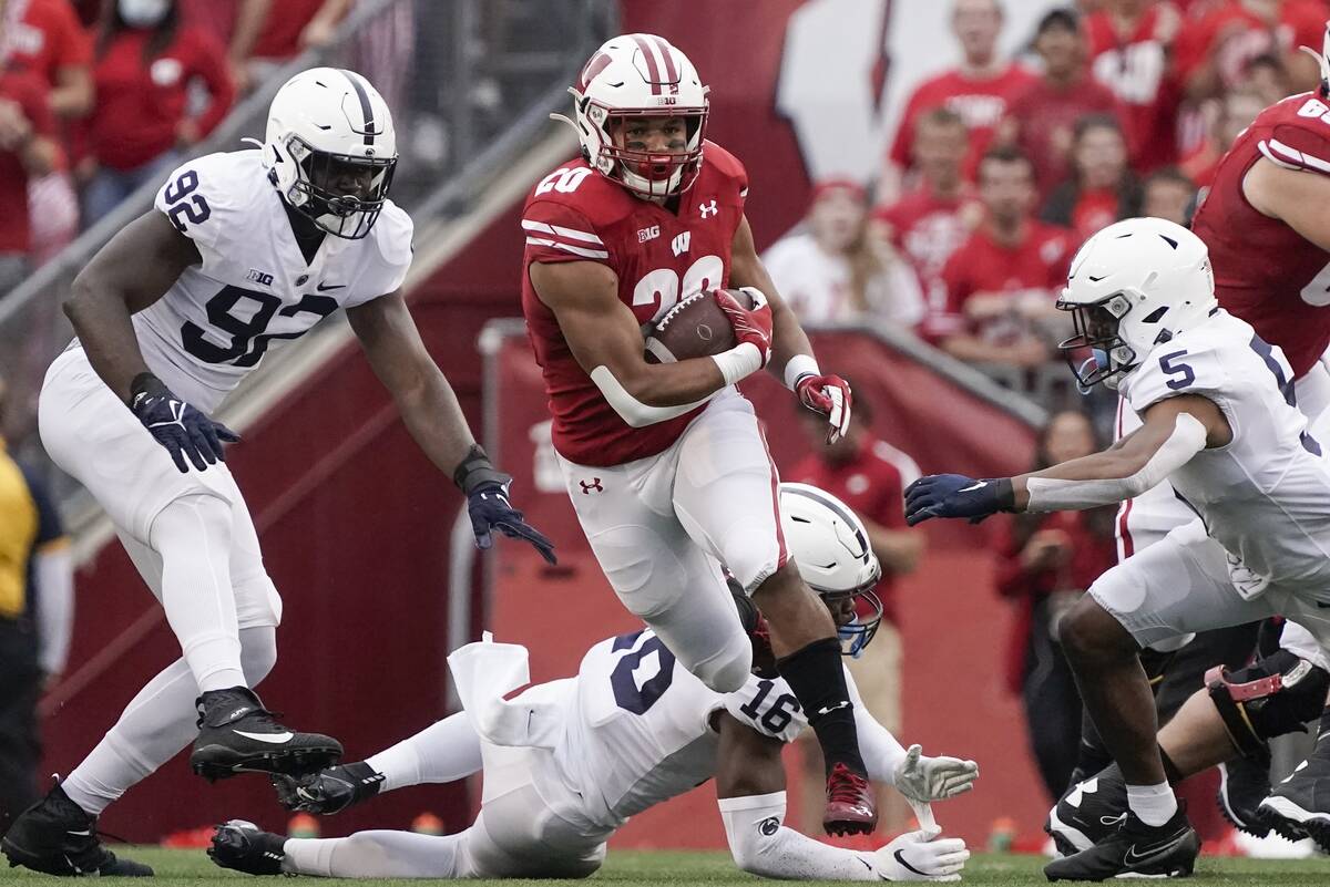 Wisconsin's Isaac Guerendo runs for a first down during the first half of an NCAA college footb ...