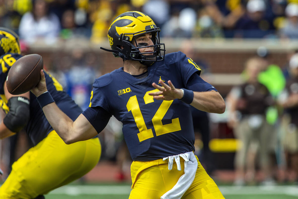 Michigan quarterback Cade McNamara (12) throws a pass in the first quarter of an NCAA college f ...