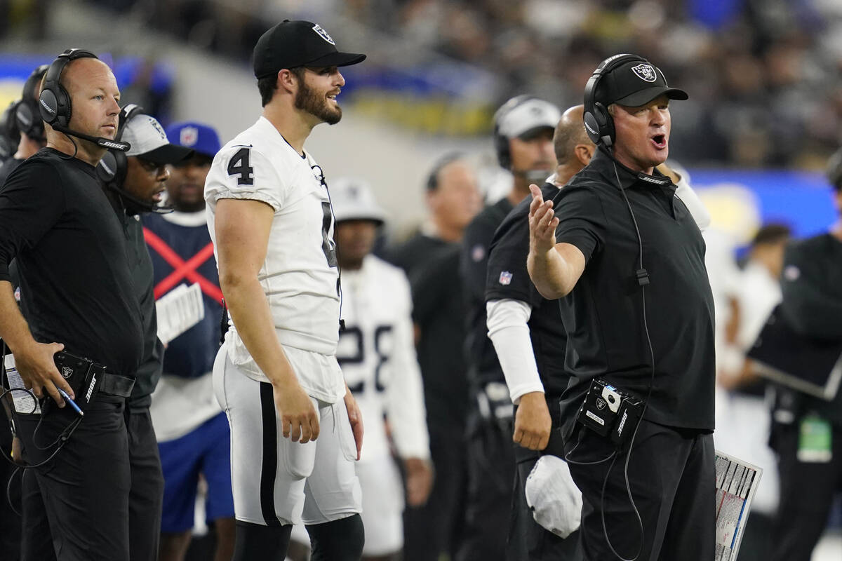 Las Vegas Raiders head coach Jon Gruden, right, argues a call in front of quarterback Derek Car ...