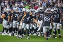 Raiders quarterback Derek Carr (4) and teammates welcome their starters to the field before the ...