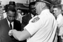 In this July 27, 1962, file photo, the Rev. Dr. Martin Luther King, Jr., is arrested by Albany' ...