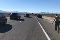 Law enforcement officers investigate a fatal two-vehicle crash on State Route 160 near Pahrump ...