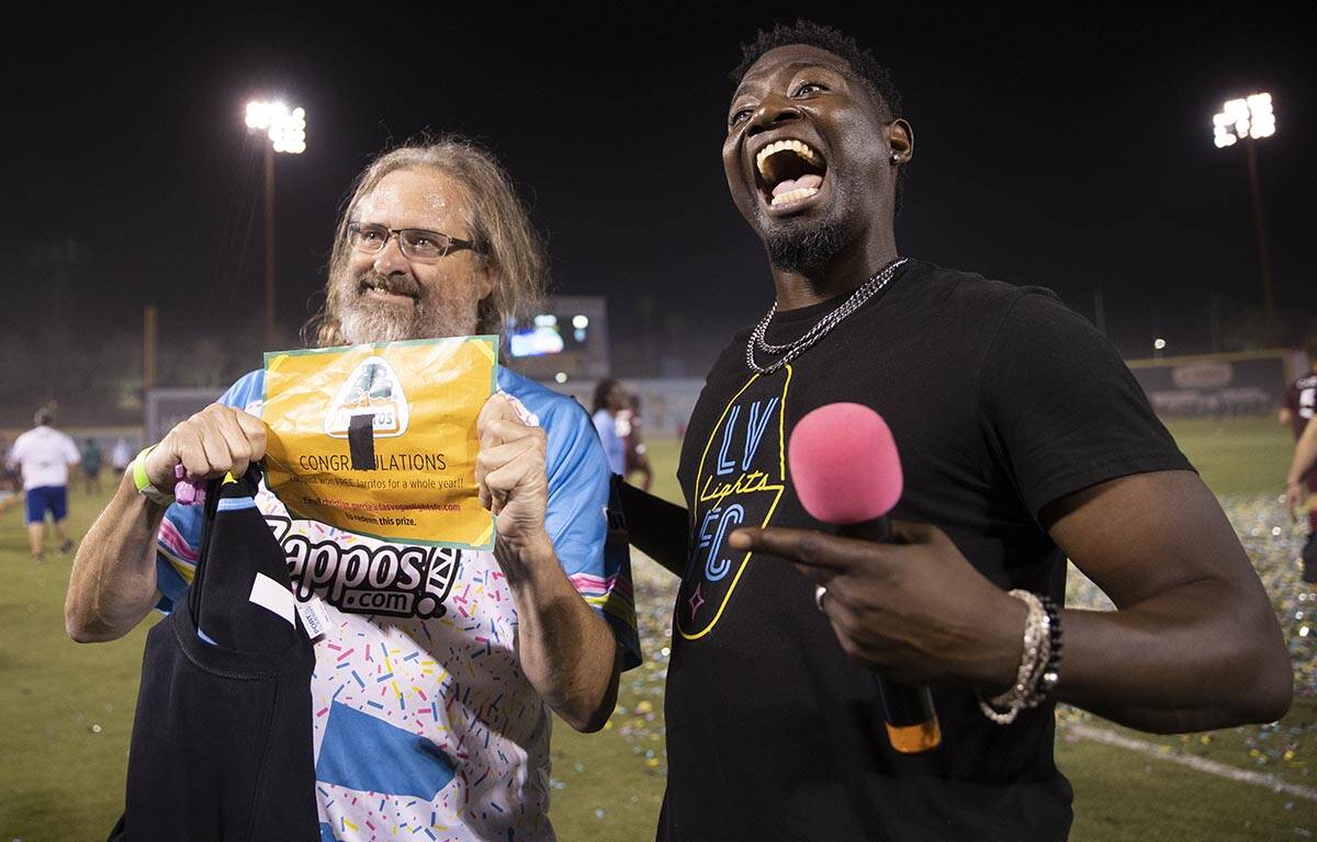 Dave Beisecker, left, shows off the golden ticket he won during the annual “$5,000 Cash ...