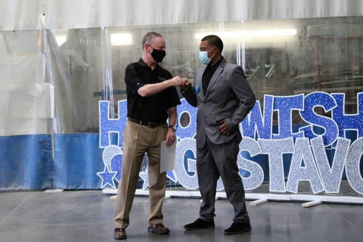 Tyler Corder, CFO of Findlay Automative, congratulates Gustavo Torres Uribe on his newly remode ...