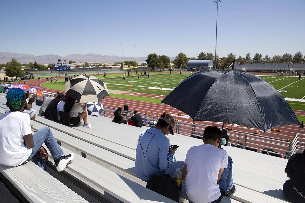 Fans attempt to stay cool during a football game between Clark High School and Cheyenne High Sc ...