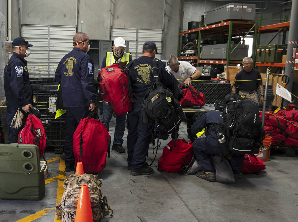 Members of the Nevada Task Force 1 sign in to return their equipments after arriving at Nevada ...