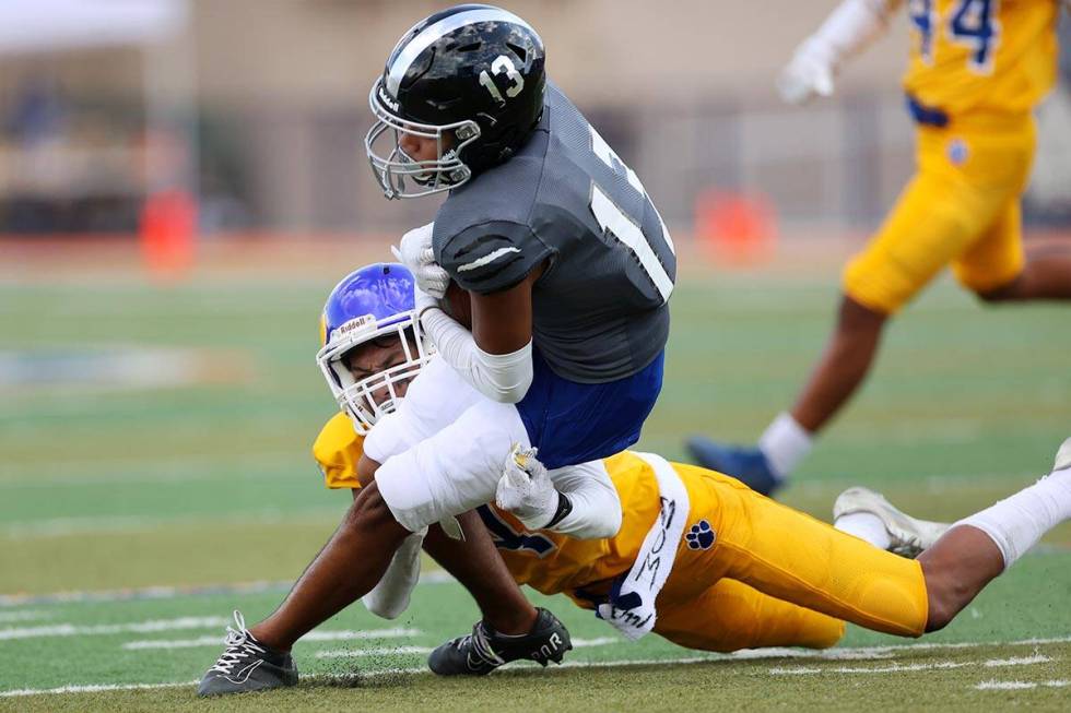 Desert Pines' Izley Manutai (13) is tackled by Orem's Shaun Niu jr. (4) after a catch in the se ...