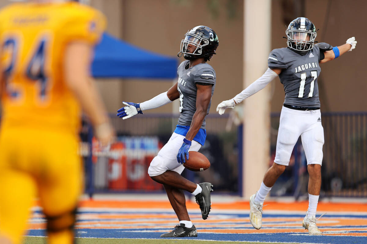 Desert Pines' Izley Manutai (13) celebrates a touchdown catch with Josiah Barron (17) in the fo ...