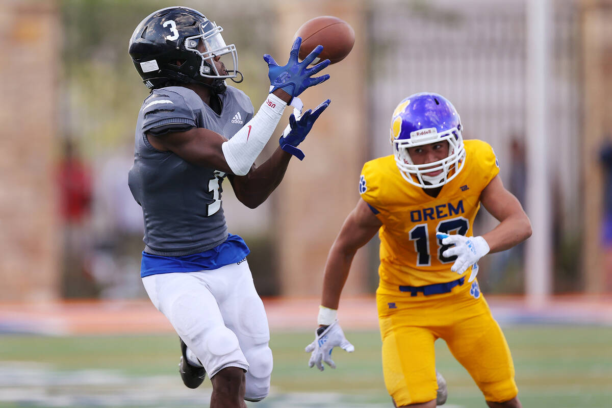 Desert Pines' Izley Manutai (13) makes a catch for a touchdown under pressure from Orem's Samps ...