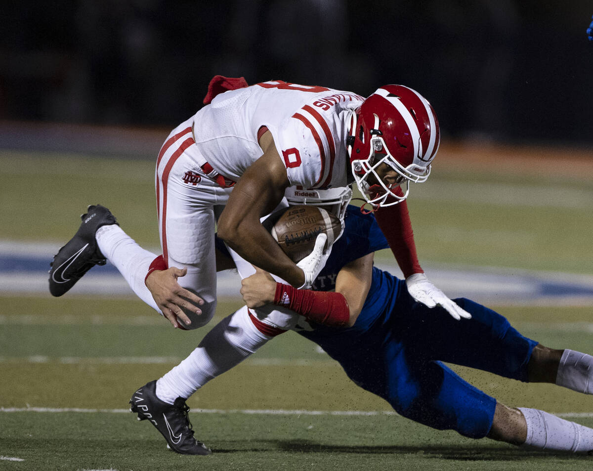 Liberty High safety Ryden-james Dacosin (33) tackles Mater Dei High wide receiver C.J. Williams ...