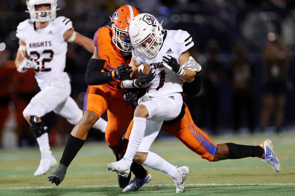 Bishop Gorman's Fabian Ross (4) and Benjamin Hudson (22) tackle Lone Peak's Cole Christensen (1 ...