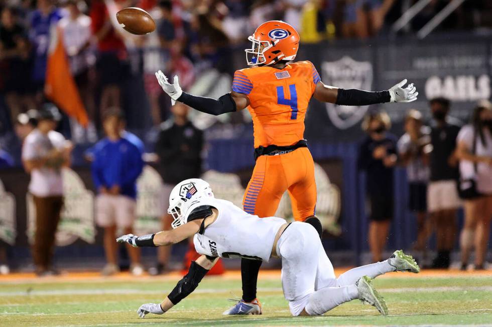 Bishop Gorman's Fabian Ross (4) breaks a pass intended for Lone Peak's Crew McChesney (3) in th ...