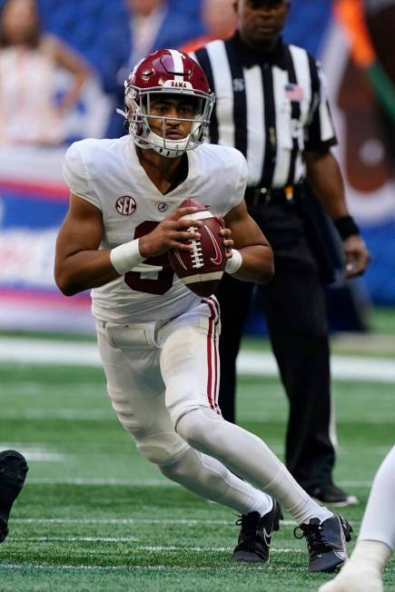 Alabama quarterback Bryce Young (9) looks for an open receiver during the first half of an NCAA ...