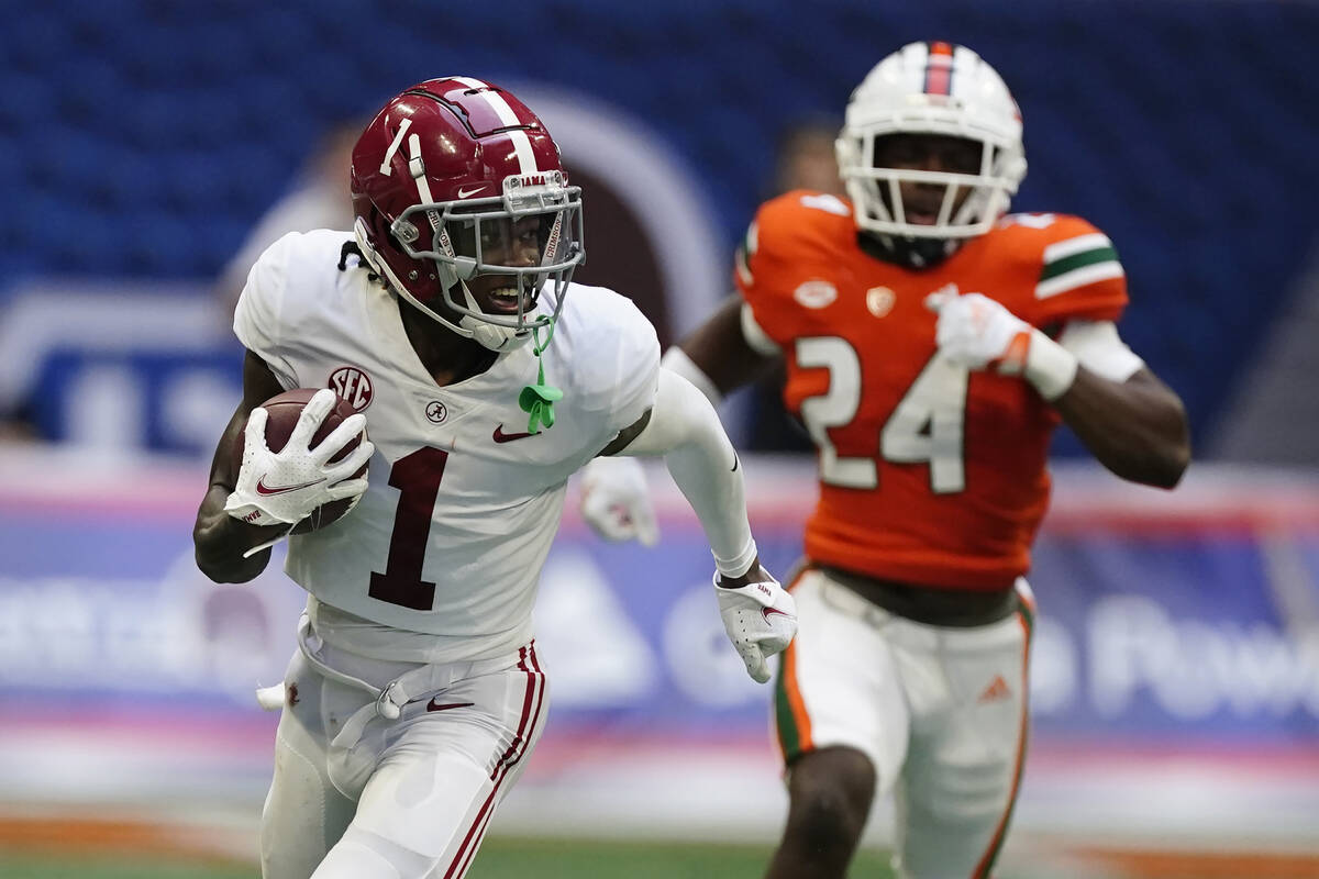 Alabama wide receiver Jameson Williams (1) scores a touchdown against the Miami during an NCAA ...