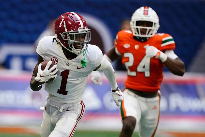 Alabama wide receiver Jameson Williams (1) scores a touchdown against the Miami during an NCAA ...