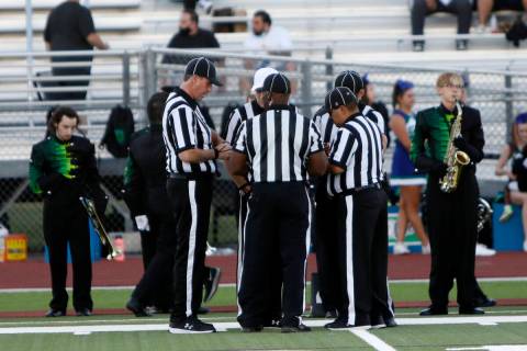 Officials, from left clockwise, head linesman Jon Spalding, referee Shane Lewis, white cap, ba ...