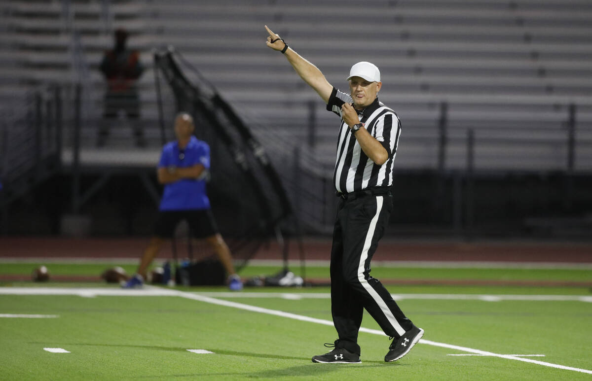 Referee Shane Lewis gestures during the first half of a football game between Palo Verde High S ...