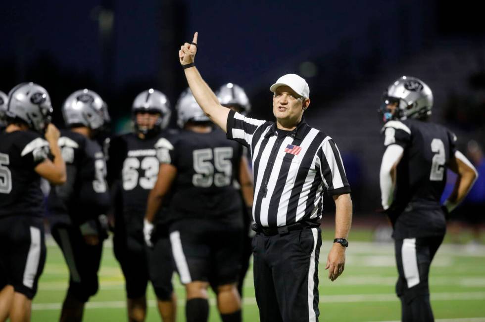 Referee Shane Lewis gestures during the first half of a football game between Palo Verde High S ...