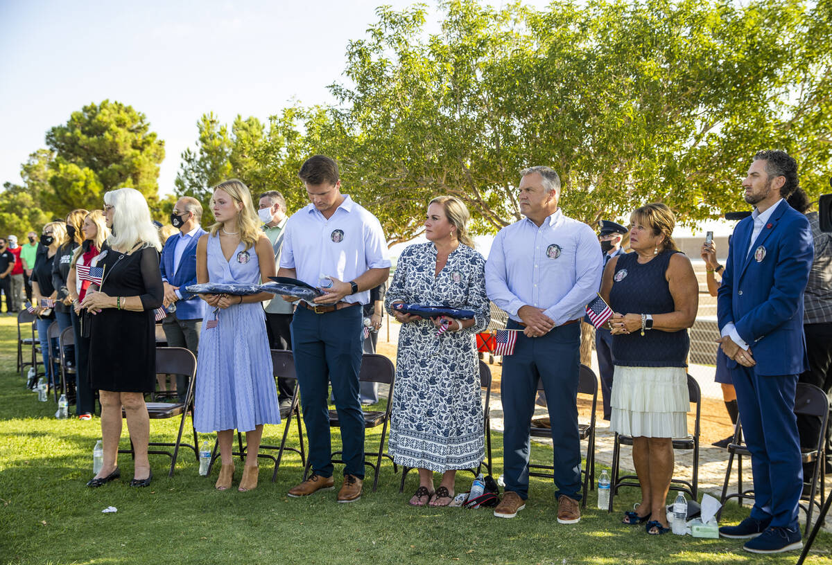 Members of the Edwards family and a former colleague stand during a ceremony to honor the memor ...