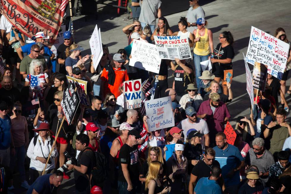 Demonstrators congregate outside Planet Hollywood during an anti-mask, anti-vaccination and fre ...