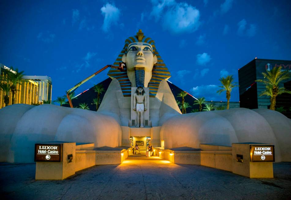 Access Solutions hangs a Raiders eye patch on the Great Sphinx of Giza replica outside of the L ...