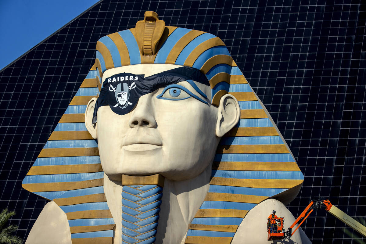 Billy Baker with Access Solutions hangs a Raiders eye patch on the Great Sphinx of Giza replica ...