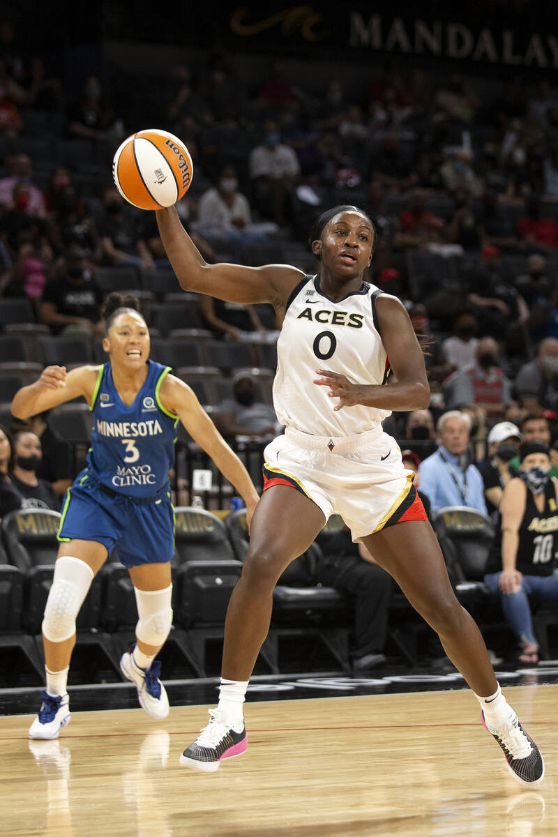 Las Vegas Aces guard Jackie Young (0) regains control of the ball while Minnesota Lynx forward/ ...