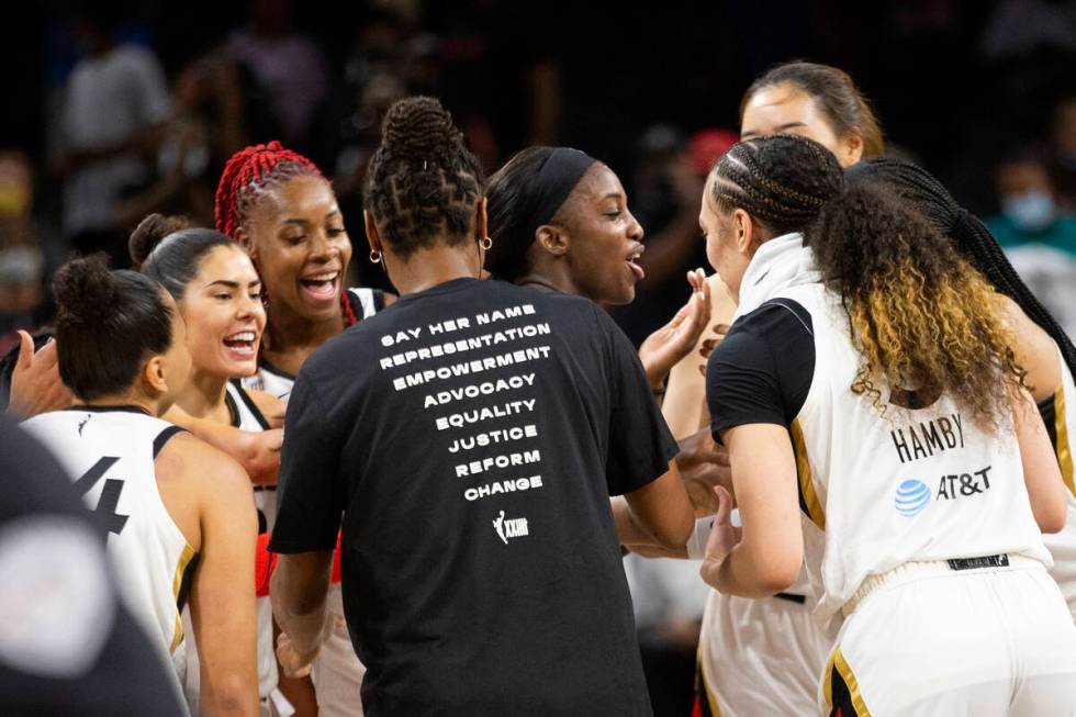 The Las Vegas Aces surround guard Jackie Young (0) after she scored 29 points, her career high, ...