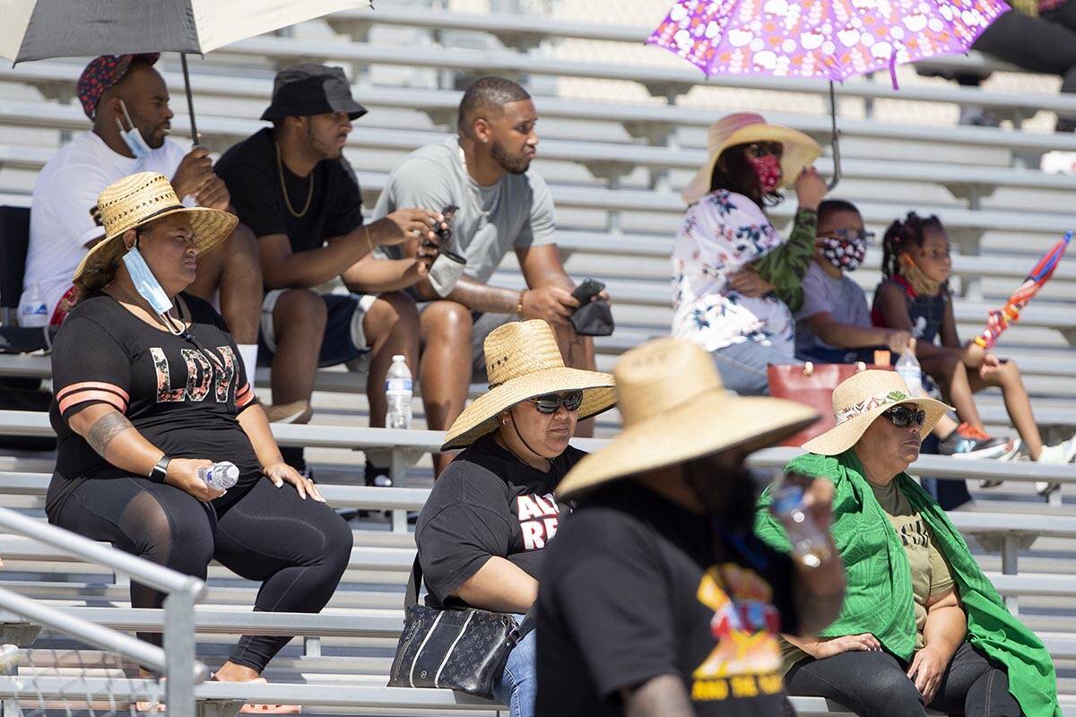 Cheyenne fans attempt to stay cool in 100-degree weather during a football game against Clark H ...
