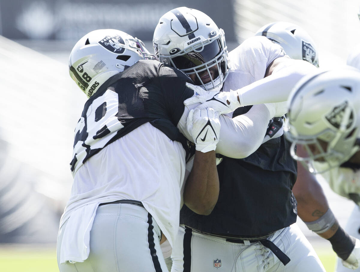 Raiders center Andre James (68) works against defensive tackle Johnathan Hankins (90) during te ...