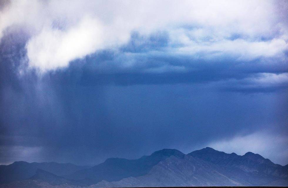 Storm clouds above mountains at the edge of Summerlin Sunday, May 16, 2021. Pop-up thunderstorm ...