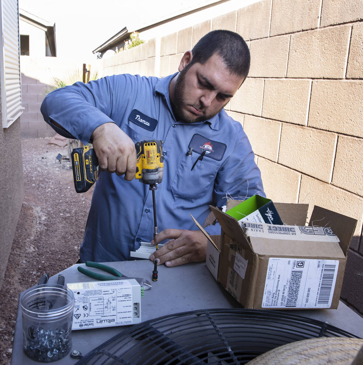 Windy City Air's technician Thomas Padron repairs an air conditioner at Vulcan St on Friday, Se ...