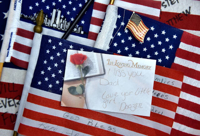 American flags and a personalized note card, gathered from the New York-New York's 9/11 heroes ...